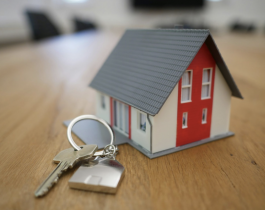Keys Sitting Next to a Toy House